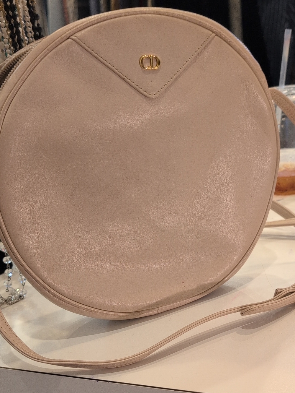 Round Crossbody Bag with Gold Accent in Light Beige